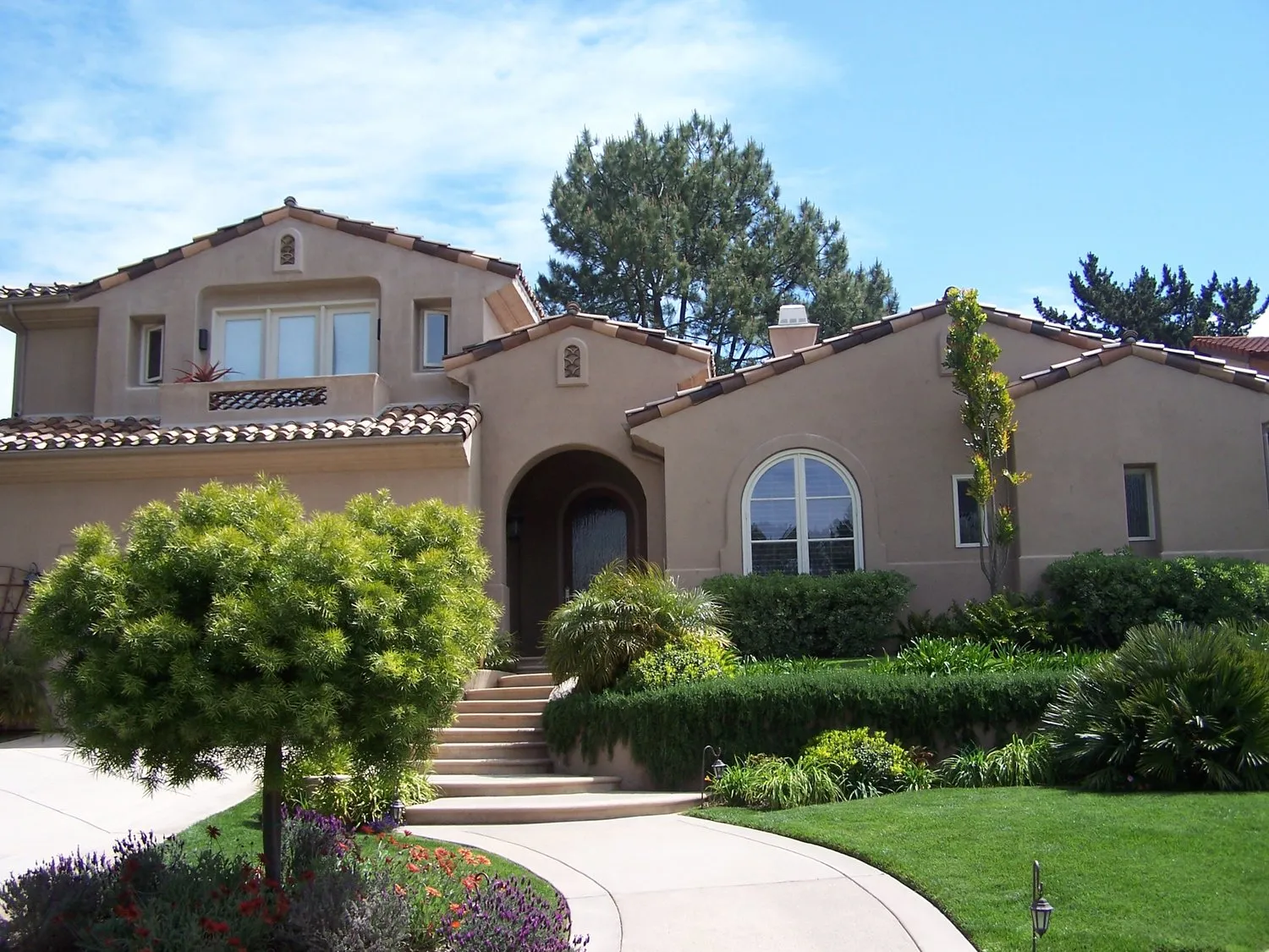 Mediterranean elevation — Warm sand-finish stucco, by Angel Brothers
