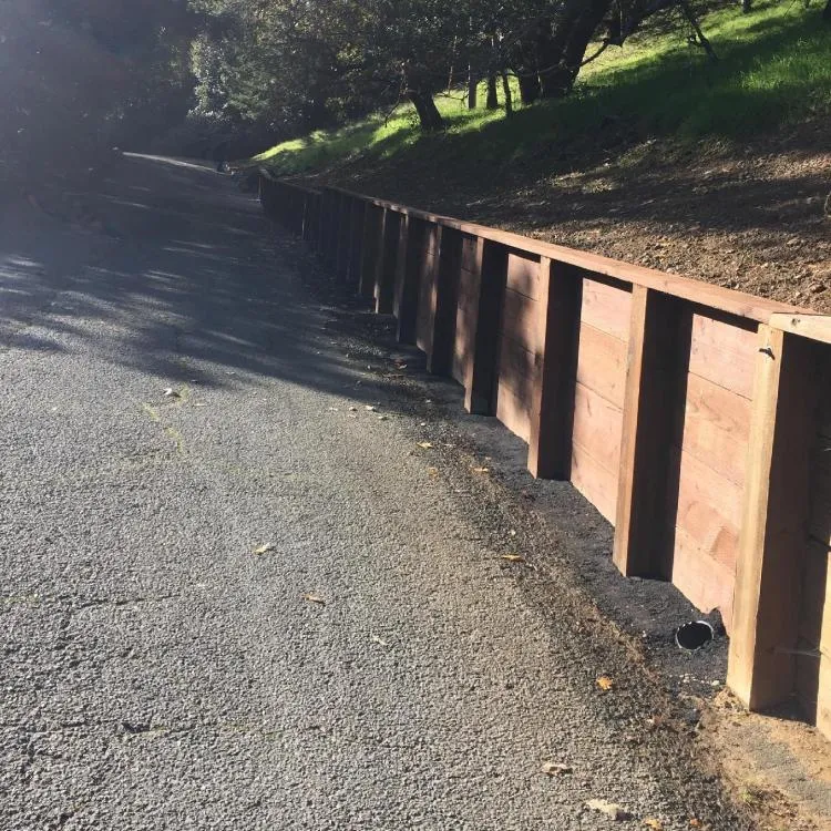 Timber retaining wall along a hillside road