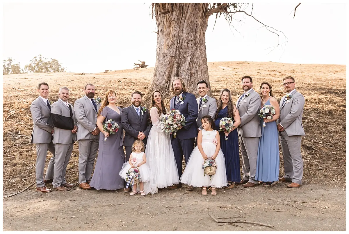 The bridal party gathered beneath a large oak at Glenn Ranch