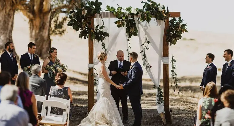 Wedding guests seated for an oak-shaded ceremony at Glenn Ranch