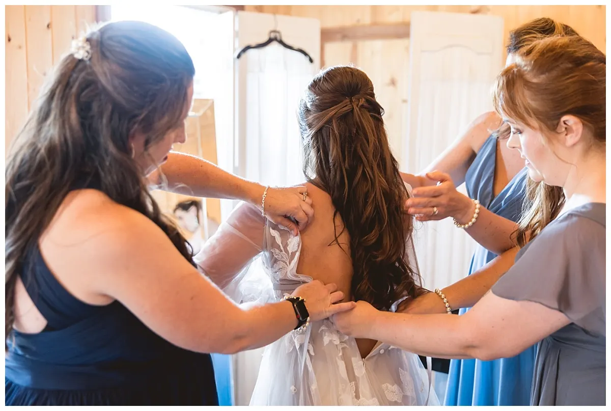 A bride getting ready in a light-filled getting-ready barn at Glenn Ranch