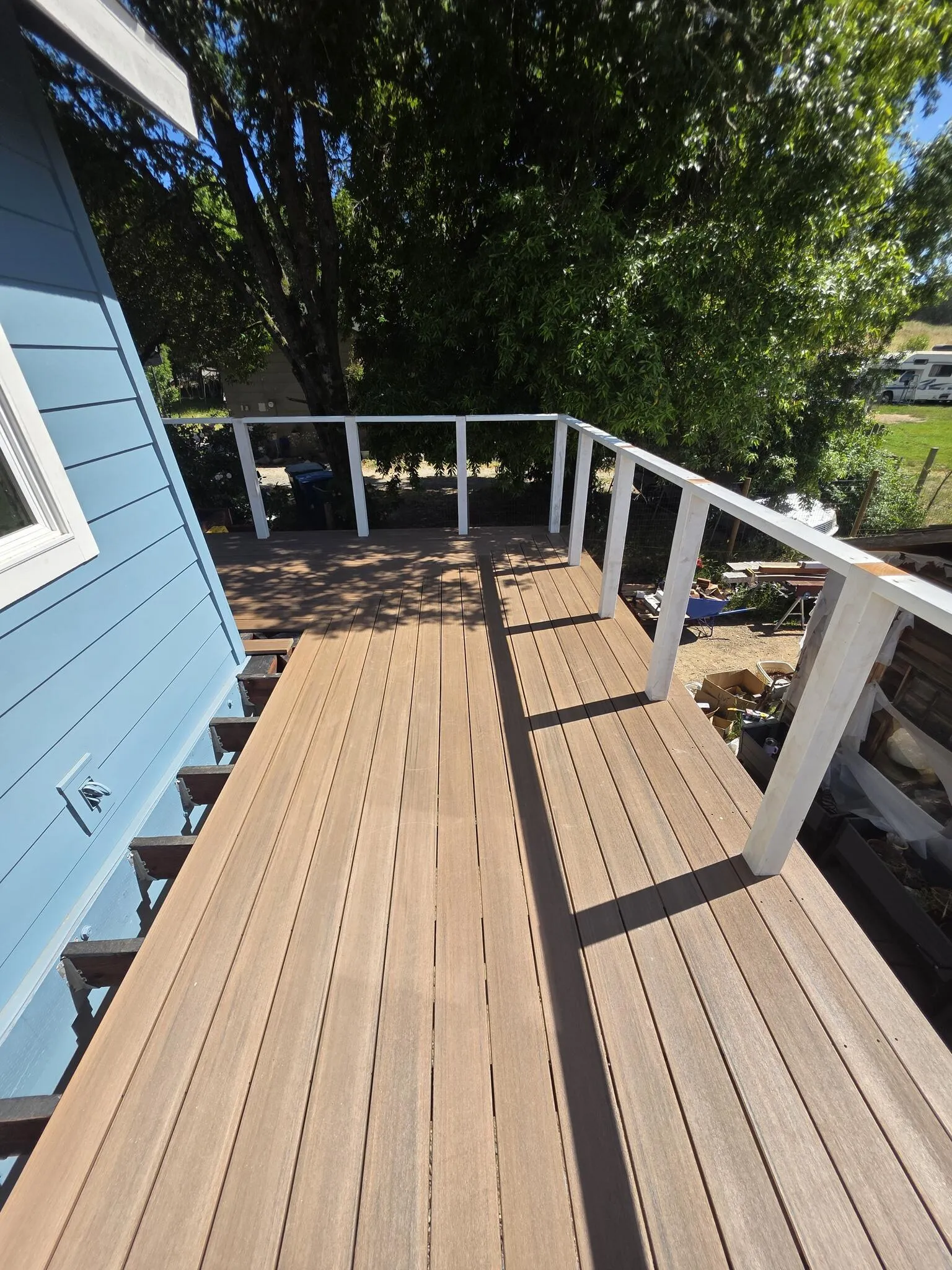Newly built deck boards against a finished home exterior