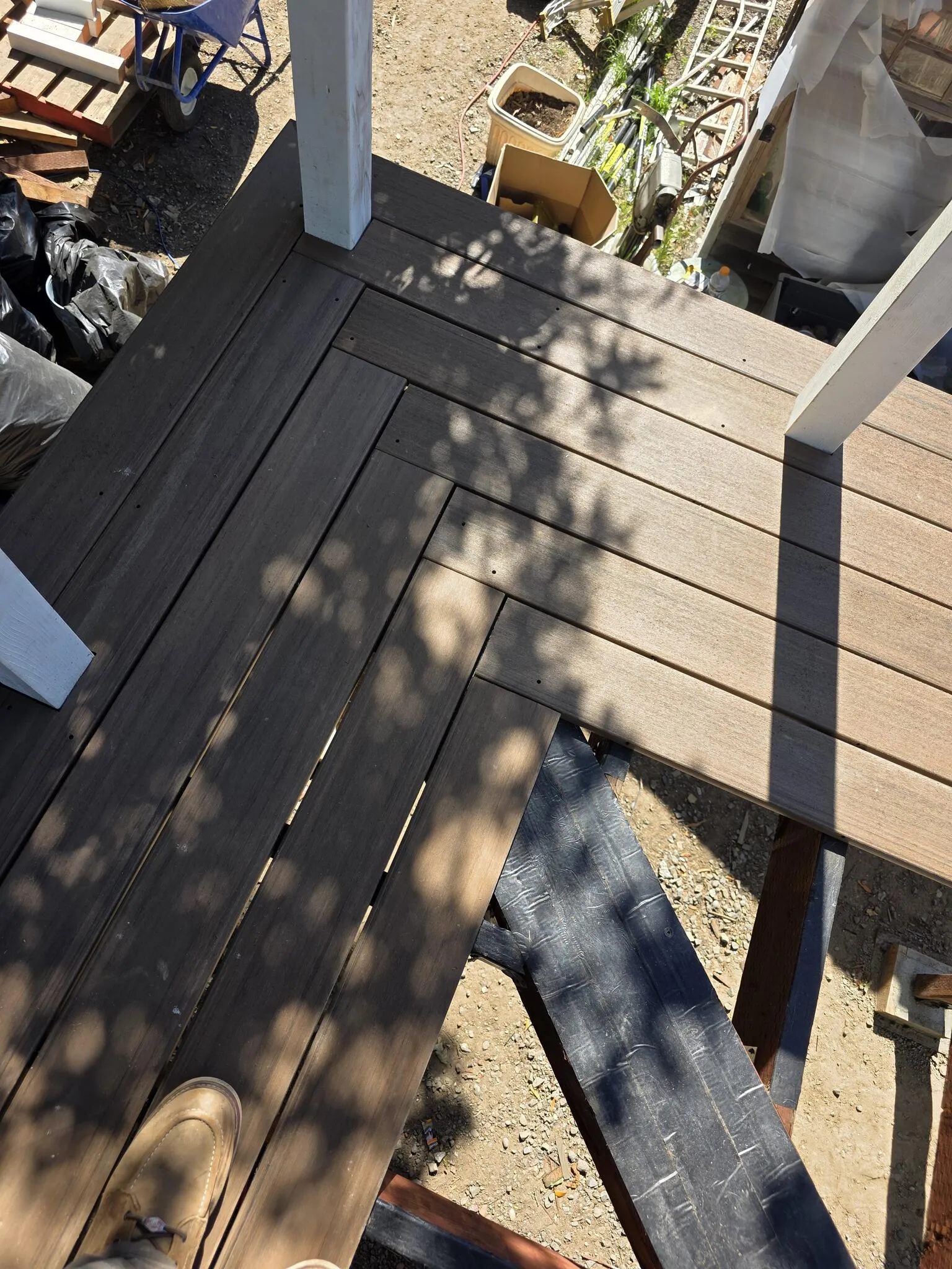 Deck and accessible ramp leading to a metal-roof outbuilding