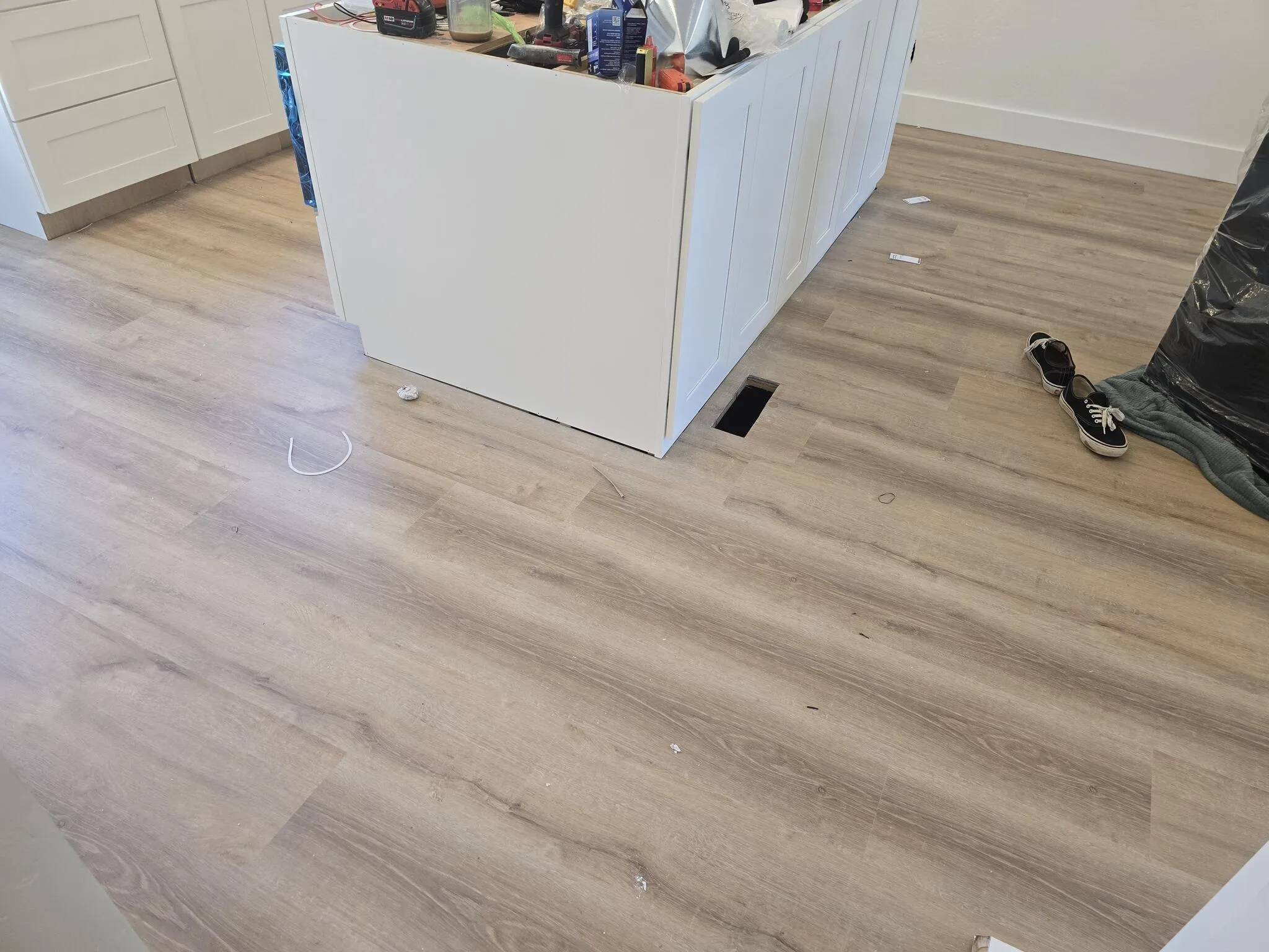 Remodeled interior room with new light wood flooring