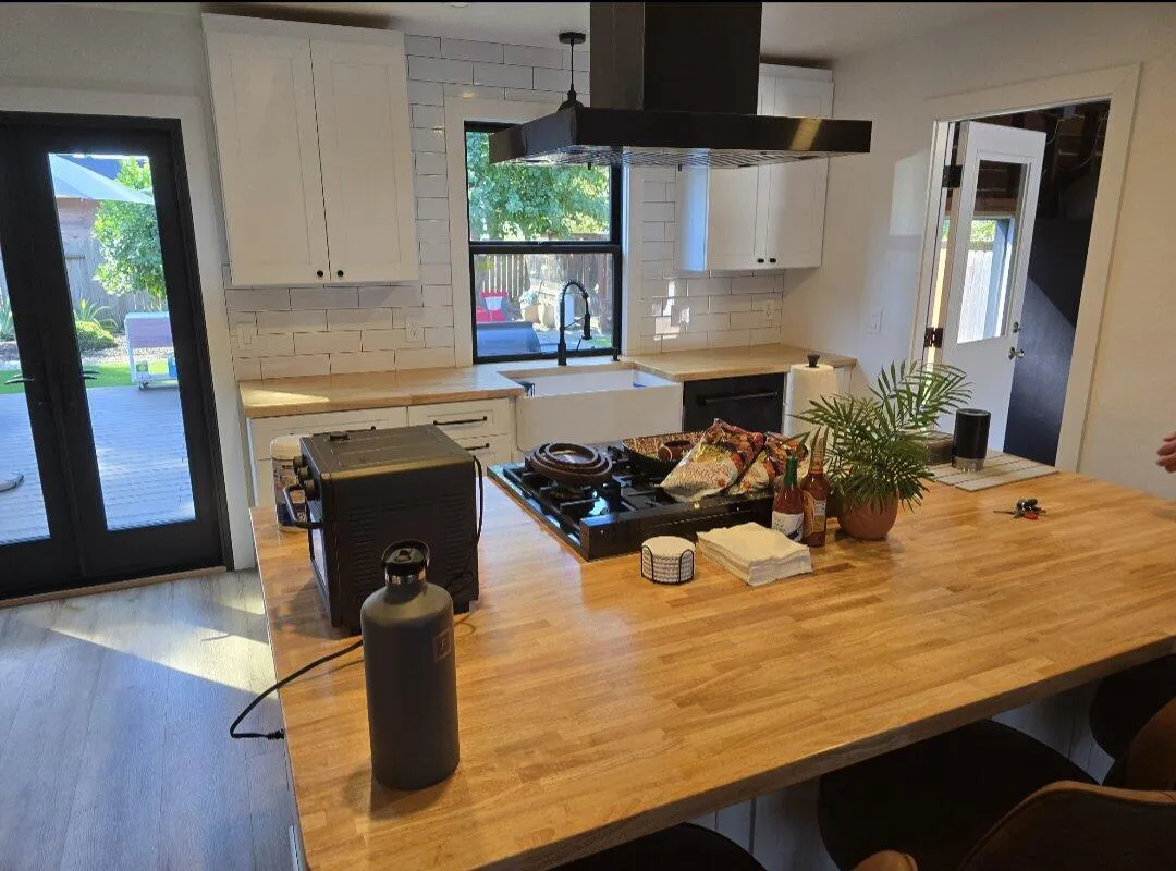 Remodeled kitchen with wood island and modern cabinetry