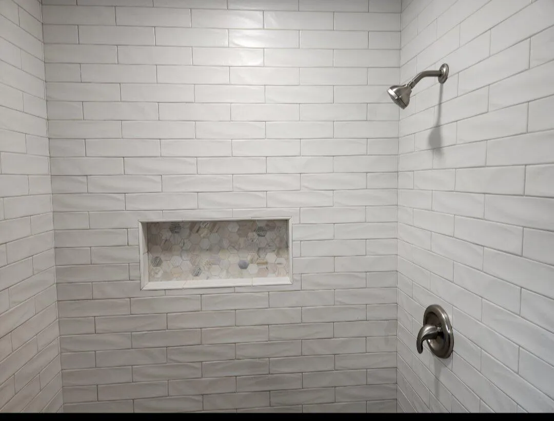 New tiled shower with full surround and glass enclosure