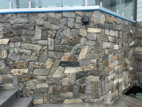 Reynoso's Stoneworks — Natural fieldstone veneer wall