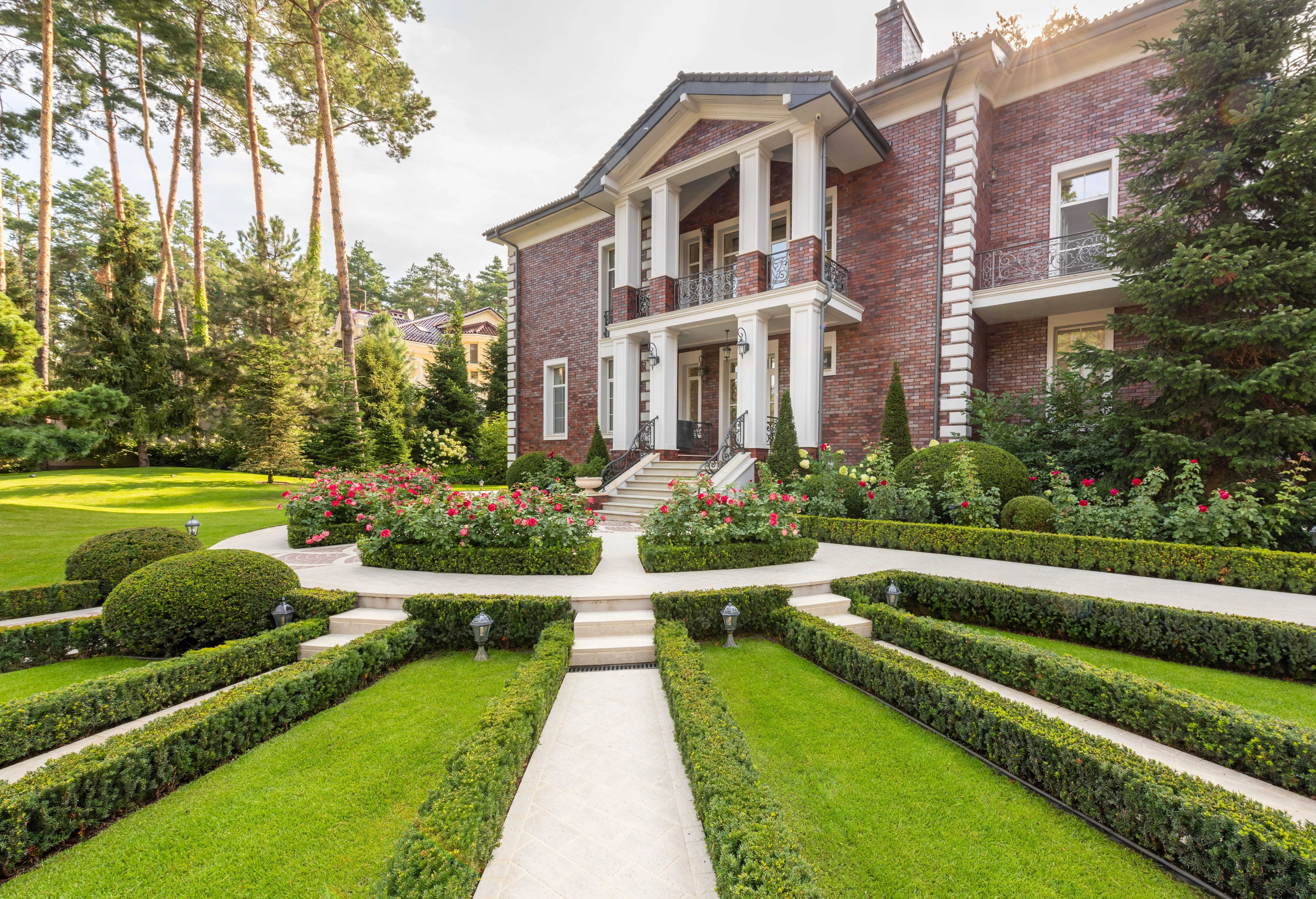 Symmetrical front garden with low parterre hedging and a paved walk