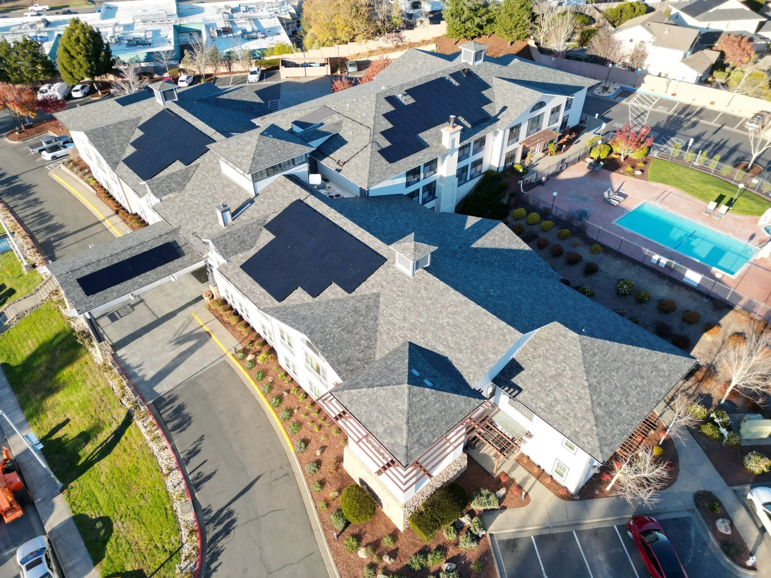 Aerial view of solar panels covering an apartment complex roof