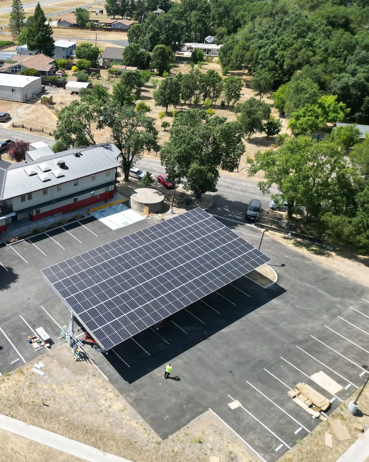 Aerial view of a large solar carport installation over a parking lot