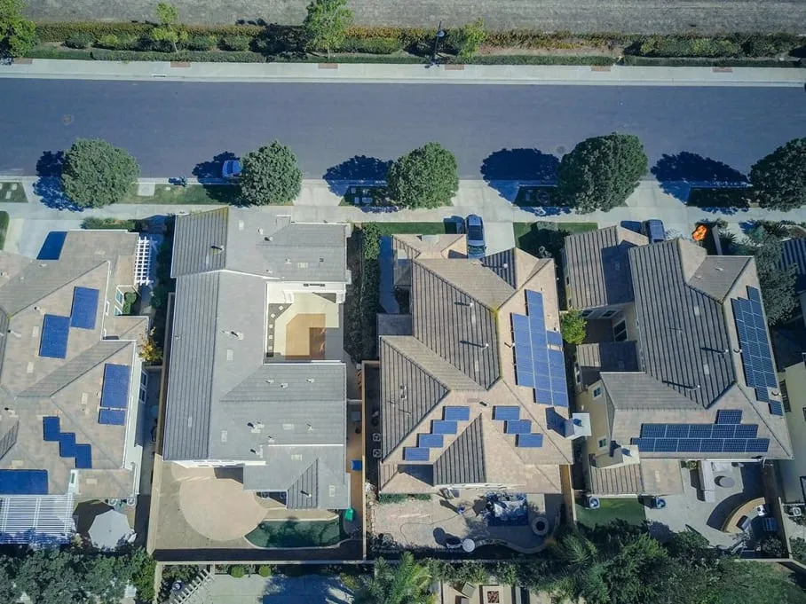 Aerial view of a neighborhood with rooftop solar installations
